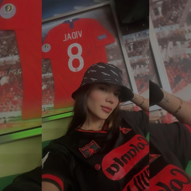 Daniela Isaza con la camiseta del América de Cali y de fondo un cuadro de Arturo Vidal - Créditos: Instagram