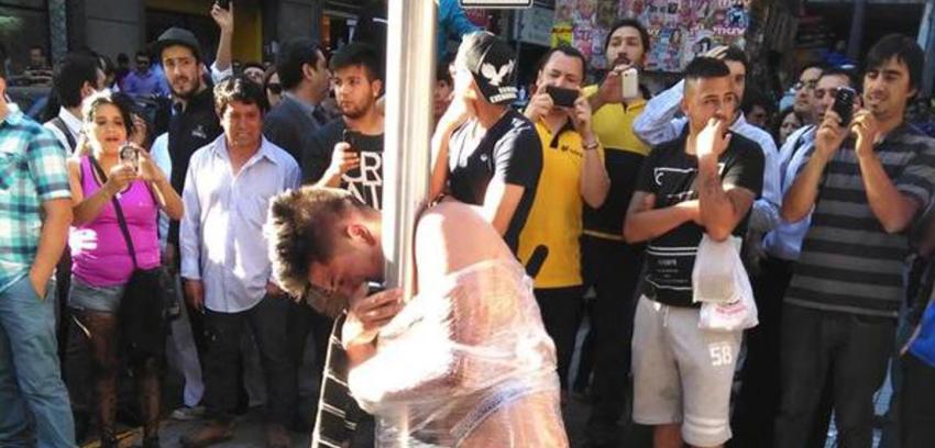 Polémica generan imágenes de delincuente desnudado por la gente tras intento de robo en Santiago