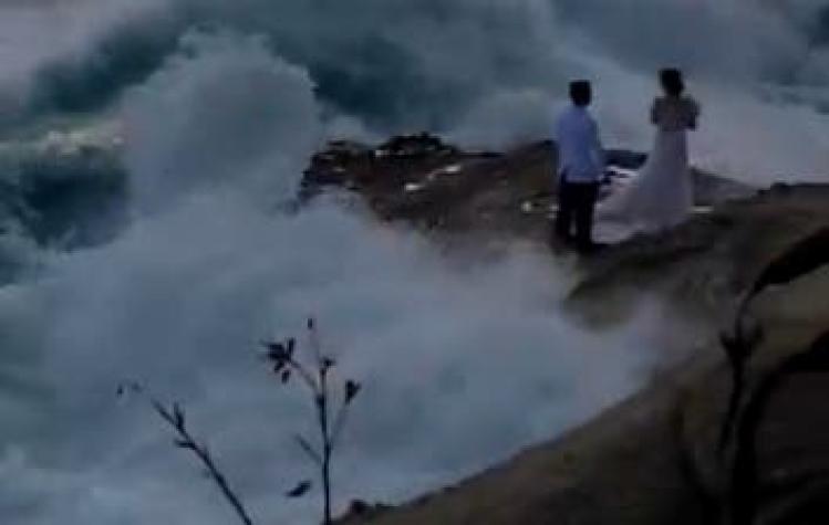 [VIDEO] Recién casados quisieron fotografiarse junto al mar y fueron arrastrados por el agua en EEUU