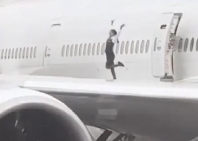Captan a una azafata bailando y sacándose fotos sobre el ala de un Boeing 777